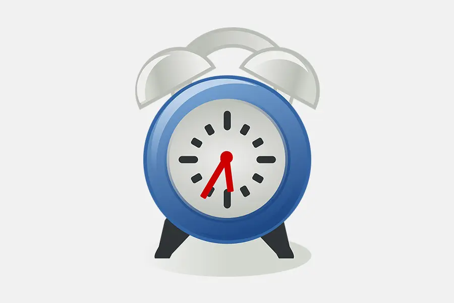 A blue alarm clock with red hands on top of it.