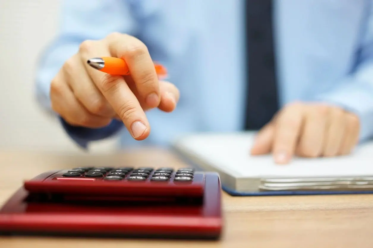 A person is using a calculator to calculate their taxes.